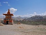 
The trail descends from Lo Manthang (3910m) to cross a stream before ascending to the Lo La (3950m) with our last view of the walled city of Lo Manthang. The trail then traverses the Tholung Valley before reaching a ridge (3580m) looking over the village of Tsarang (3560m). The trail descends to cross the Tsarang Chu, and climbs 125m to Tsarang, the second largest village in Mustang. I walked across the village to see the entrance chorten nicely framing the village and the Tsarang gompa and old dzong.
